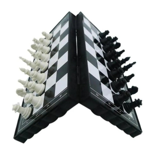 Folding chess set with black and white pieces on a white background
