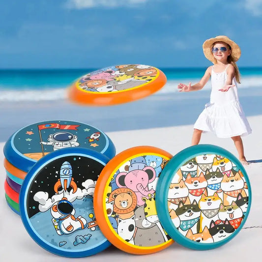 Colorful children's frisbees with cartoon designs on a beach